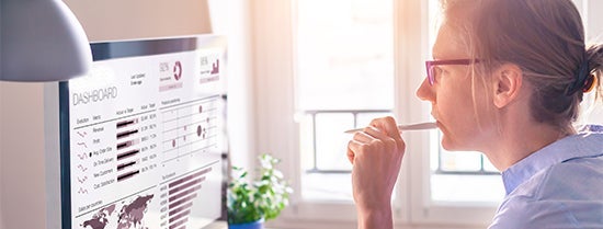 Woman contemplating in front of a computer screen